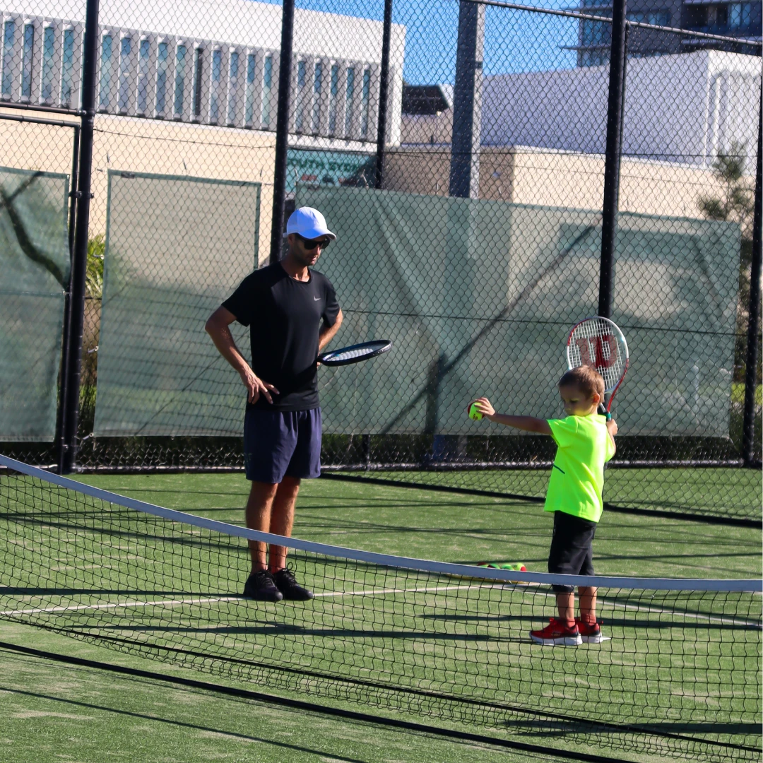 Coach giving focused one-on-one feedback to a junior player during a private tennis lesson at Ryde Multisport & Racquet Centre
